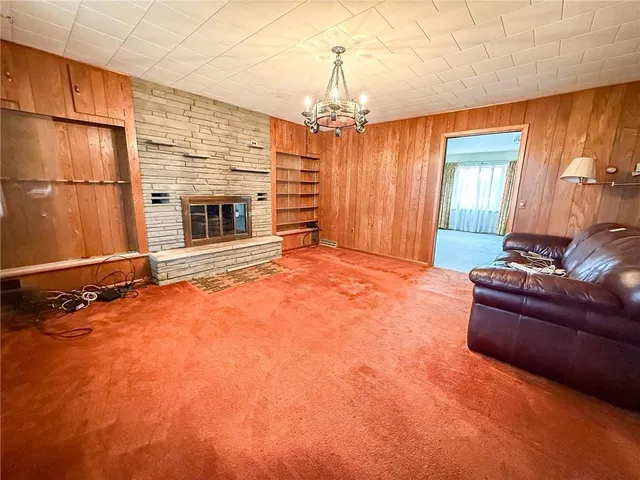a living room with fireplace furniture and a chandelier