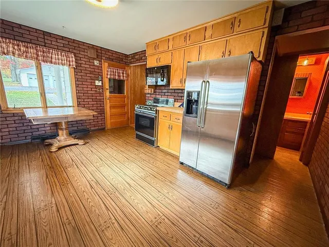 a room with wooden floor and furniture