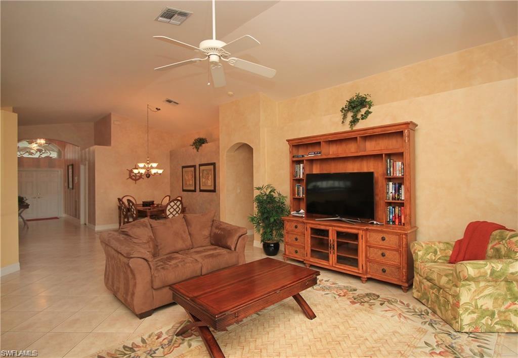 2322 Butterfly Palm Drive Naples, FL 34119 - Photo 14 of 32 a living room with furniture and a flat screen tv