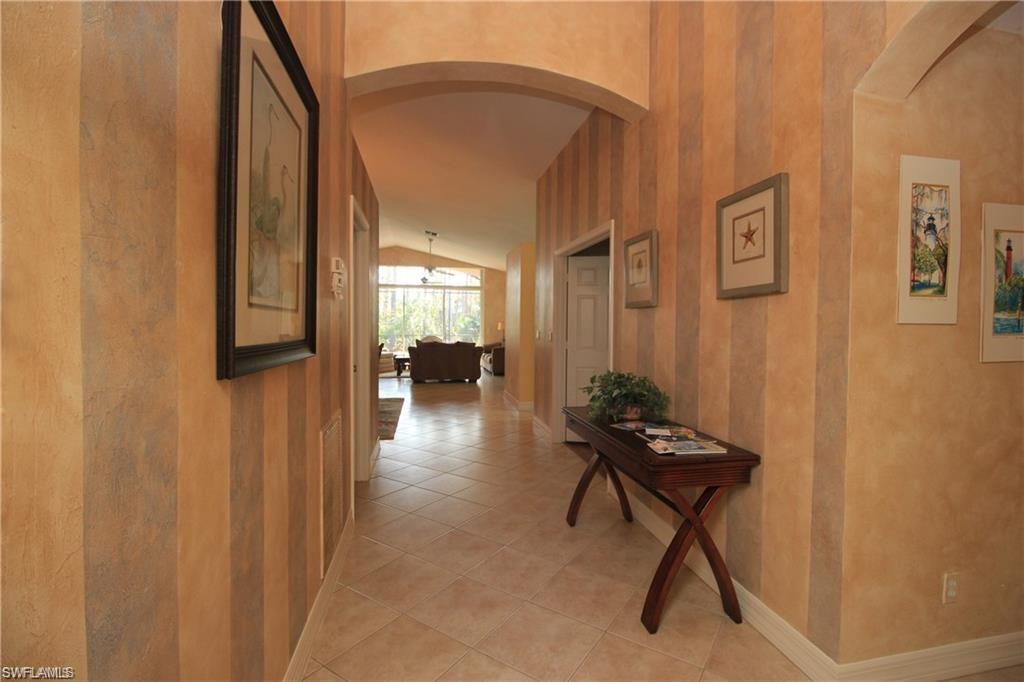 2322 Butterfly Palm Drive Naples, FL 34119 - Photo 2 of 32 a living room with furniture and a window