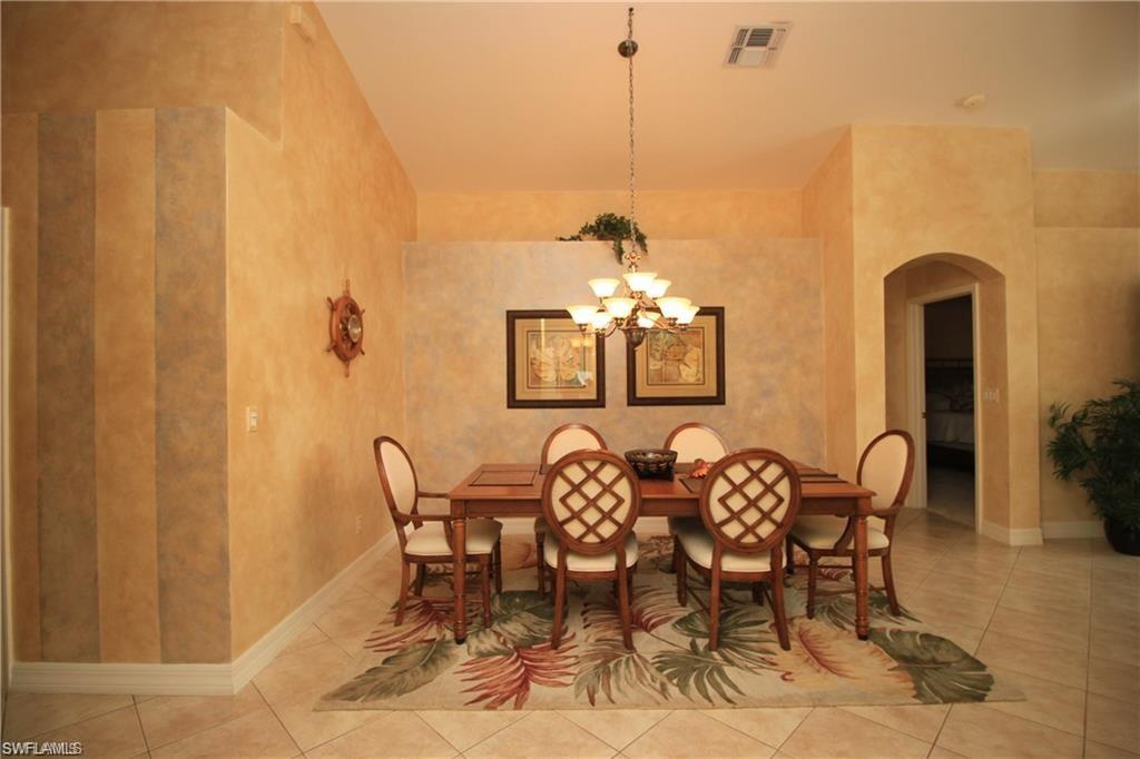 2322 Butterfly Palm Drive Naples, FL 34119 - Photo 4 of 32 a view of a dining room with furniture and chandelier