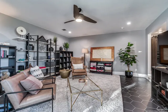 a living room with lots of furniture and a flat screen tv