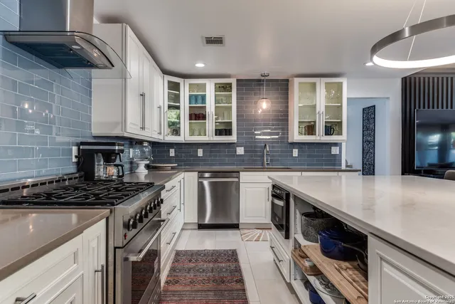 a kitchen with stainless steel appliances granite countertop a stove and a sink