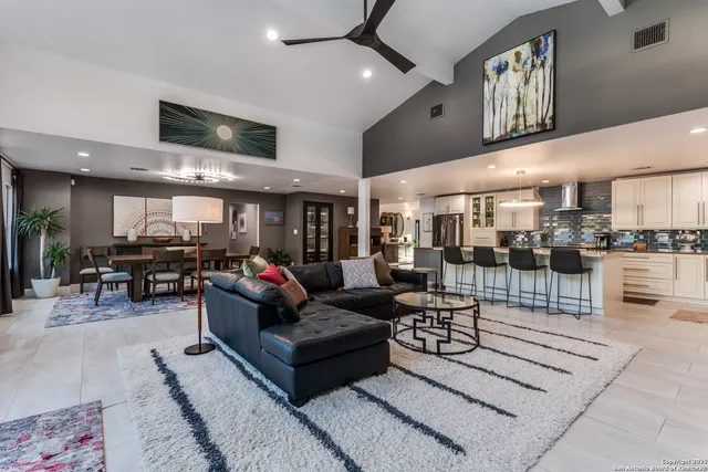 a living room with furniture and a view of kitchen