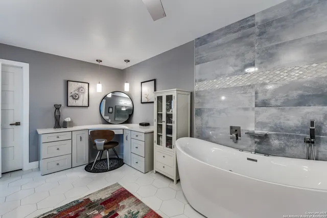 a spacious bathroom with a tub double vanity and mirrors