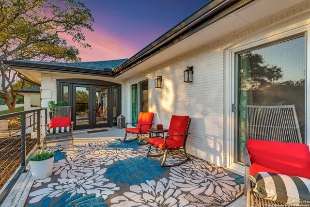 a backyard of a house with yard and outdoor seating