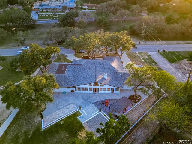 an aerial view of residential houses with outdoor space