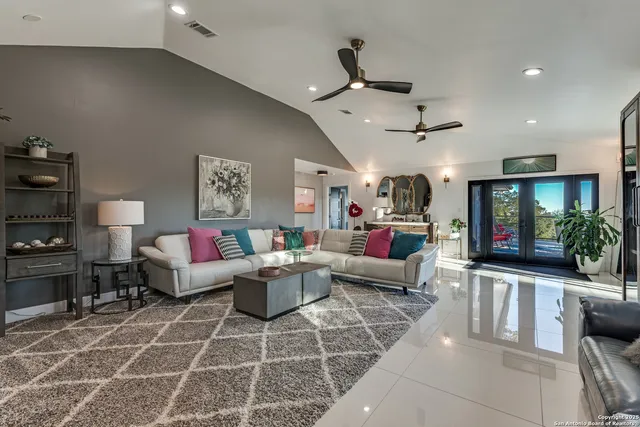 a living room with furniture and a chandelier