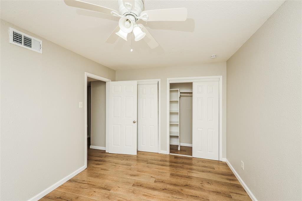 4618 Reiger Avenue, Unit 104 Dallas, TX 75246 - Photo 14 of 19 an empty room with closet and a ceiling fan