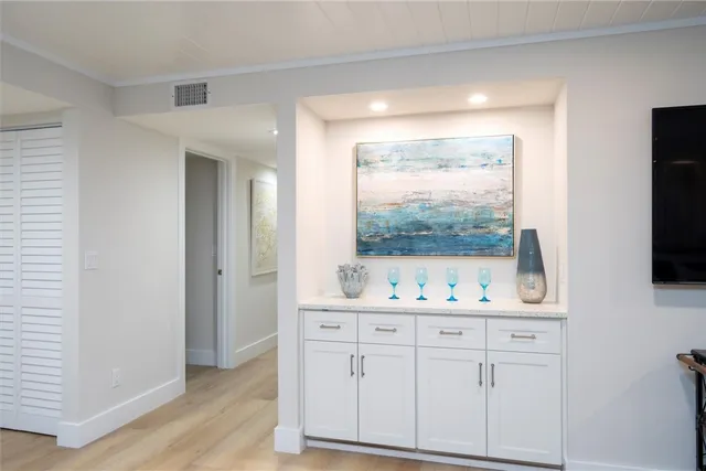 a room with white cabinets and a window