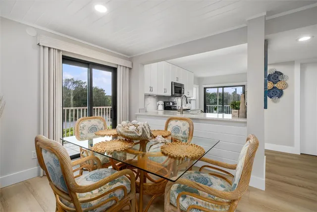 a dining room with furniture wooden floor and a rug