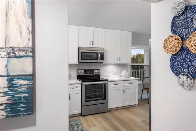 a kitchen with stainless steel appliances granite countertop a stove and a refrigerator