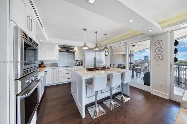 a kitchen with stainless steel appliances granite countertop a sink and a stove