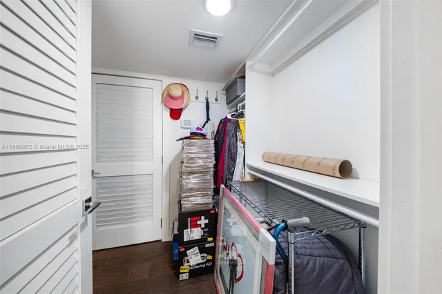 a bedroom with a bed and a walk in closet