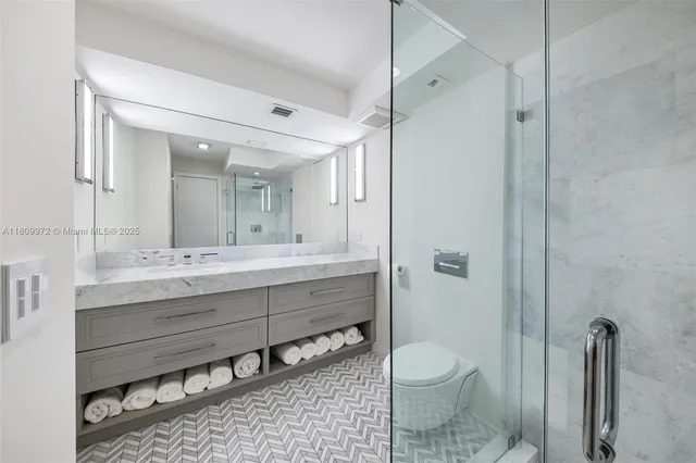 a spacious bedroom with a bed and a flat screen tv