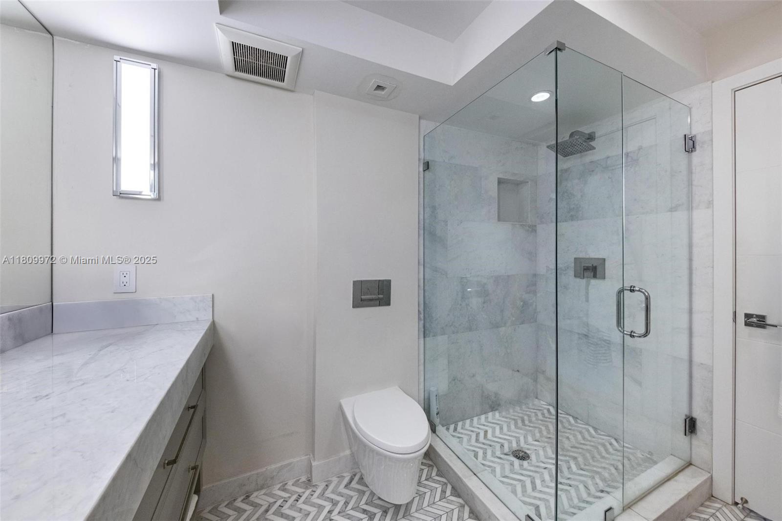 2901 South Bayshore Drive, Unit 17G/H Miami, FL 33133 - Photo 32 of 81 a bathroom with a granite countertop sink a toilet and shower