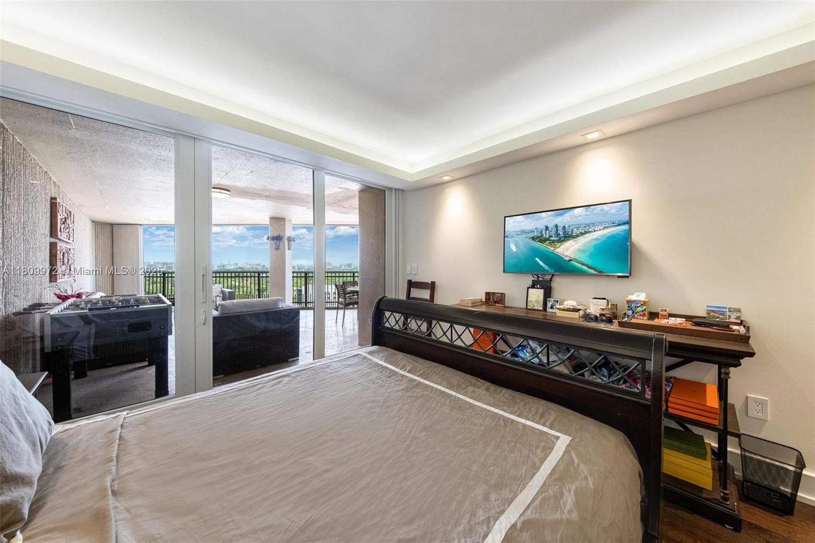 2901 South Bayshore Drive, Unit 17G/H Miami, FL 33133 - Photo 35 of 81 a living room with furniture a flat screen tv and a floor to ceiling window