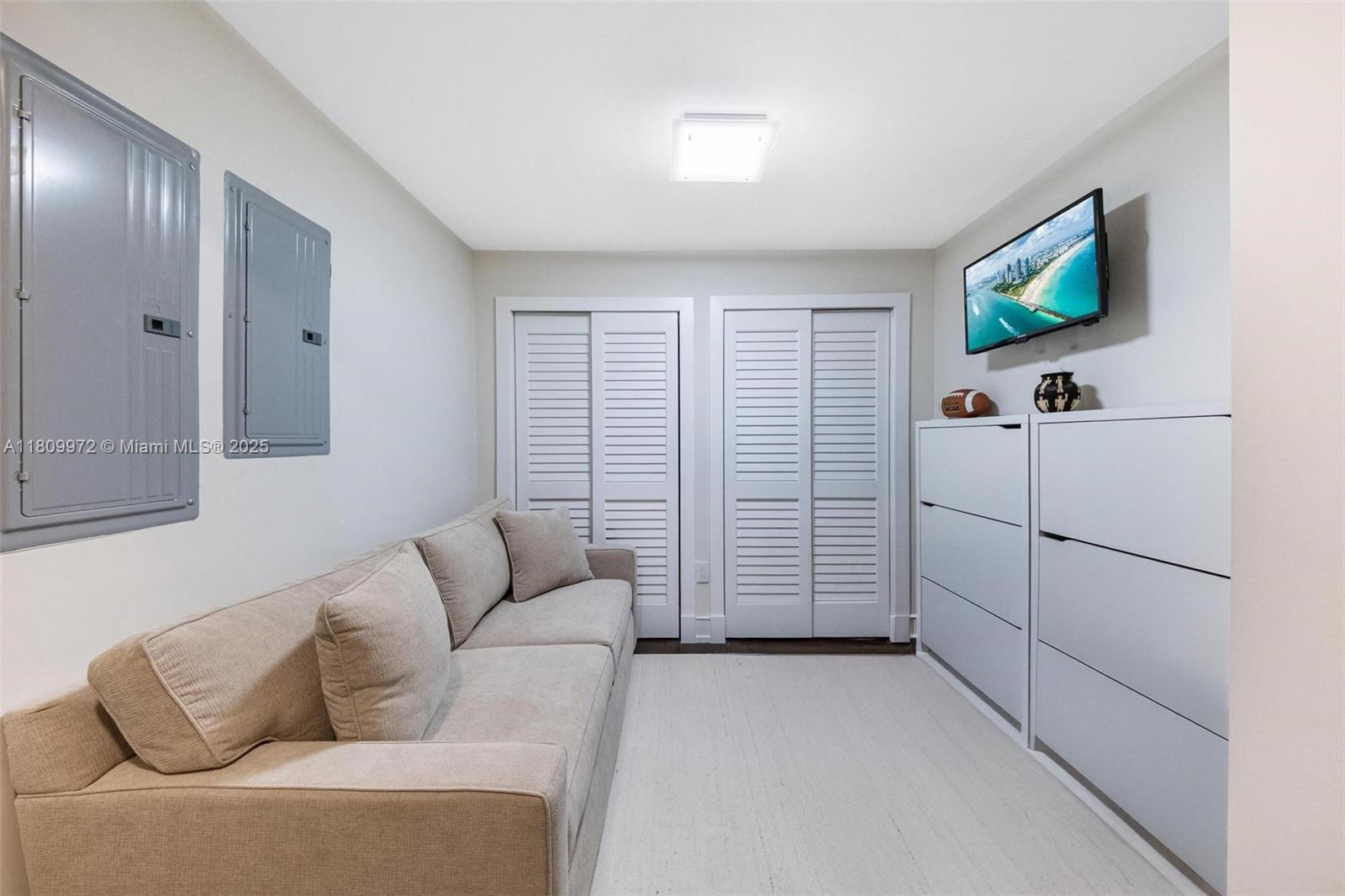 2901 South Bayshore Drive, Unit 17G/H Miami, FL 33133 - Photo 37 of 81 a living room with furniture and a flat screen tv