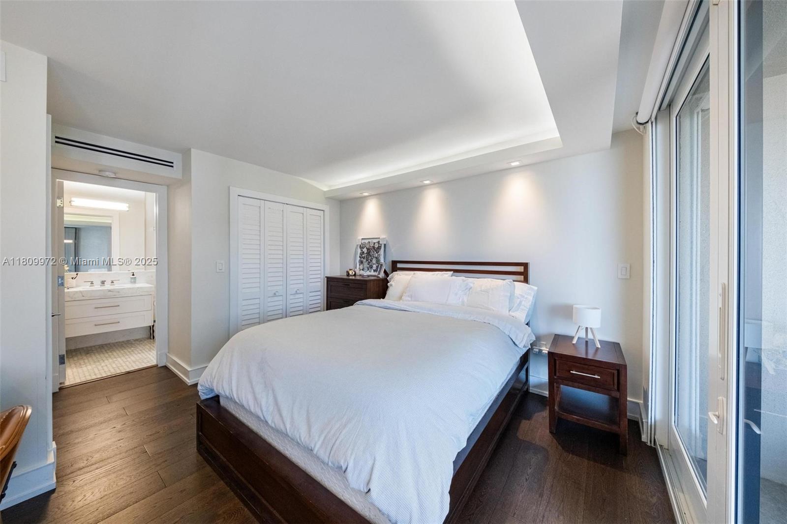 2901 South Bayshore Drive, Unit 17G/H Miami, FL 33133 - Photo 43 of 81 a bedroom with a bed and a walk in closet