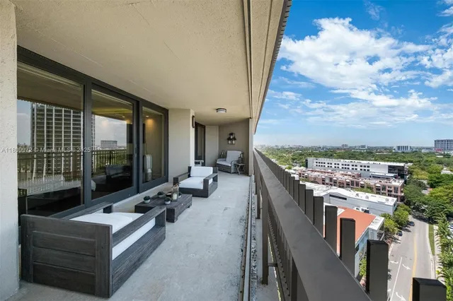 an aerial view of a house with a yard and sitting area