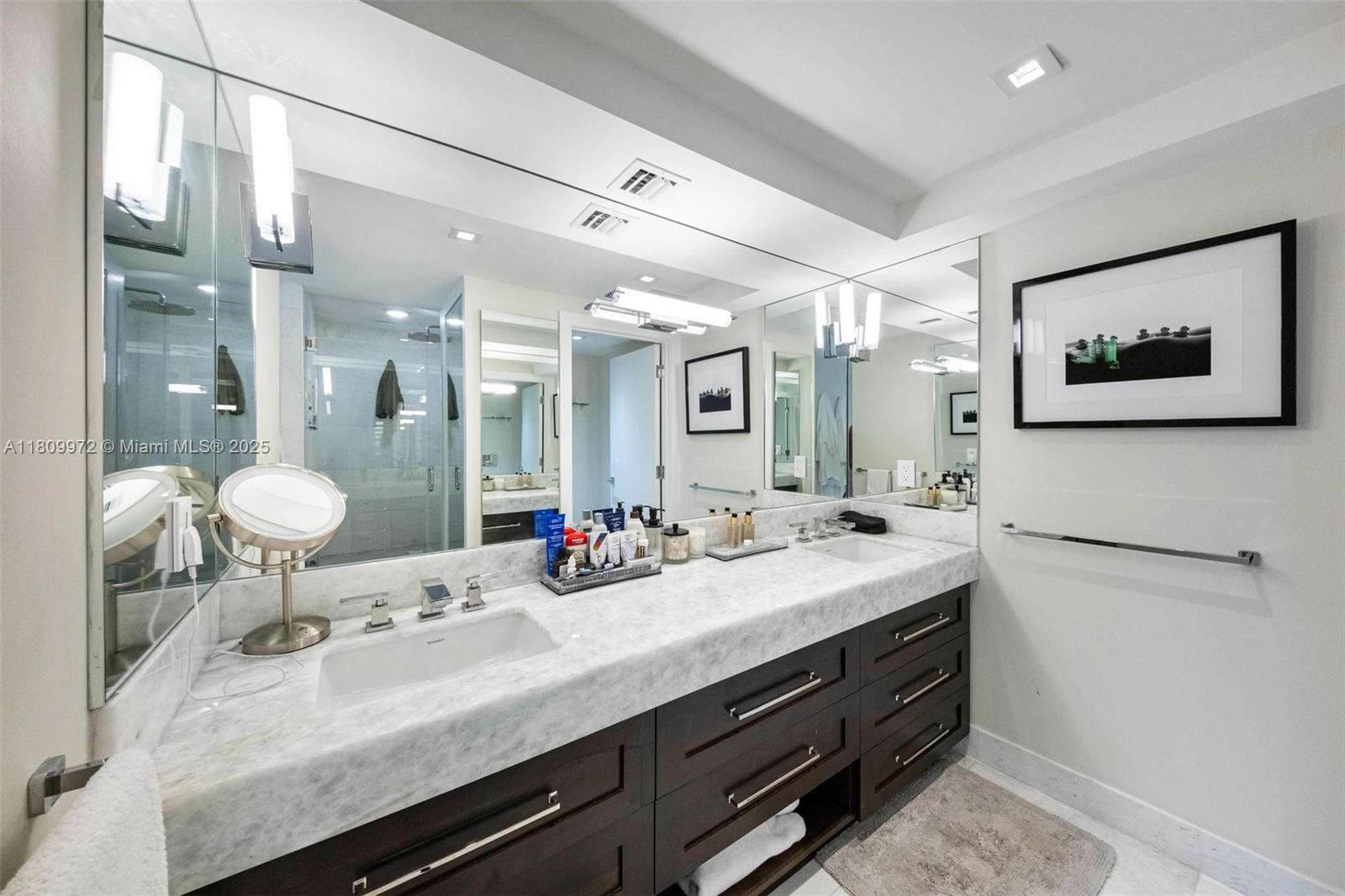 2901 South Bayshore Drive, Unit 17G/H Miami, FL 33133 - Photo 53 of 81 a bathroom with a sink double vanity and a mirror
