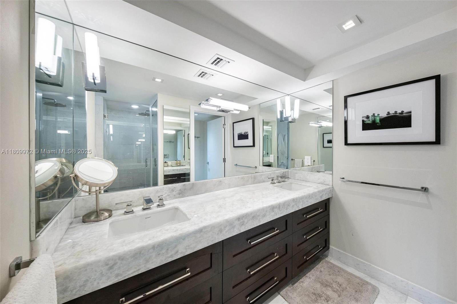 2901 South Bayshore Drive, Unit 17G/H Miami, FL 33133 - Photo 54 of 81 a bathroom with a granite countertop sink mirror and vanity