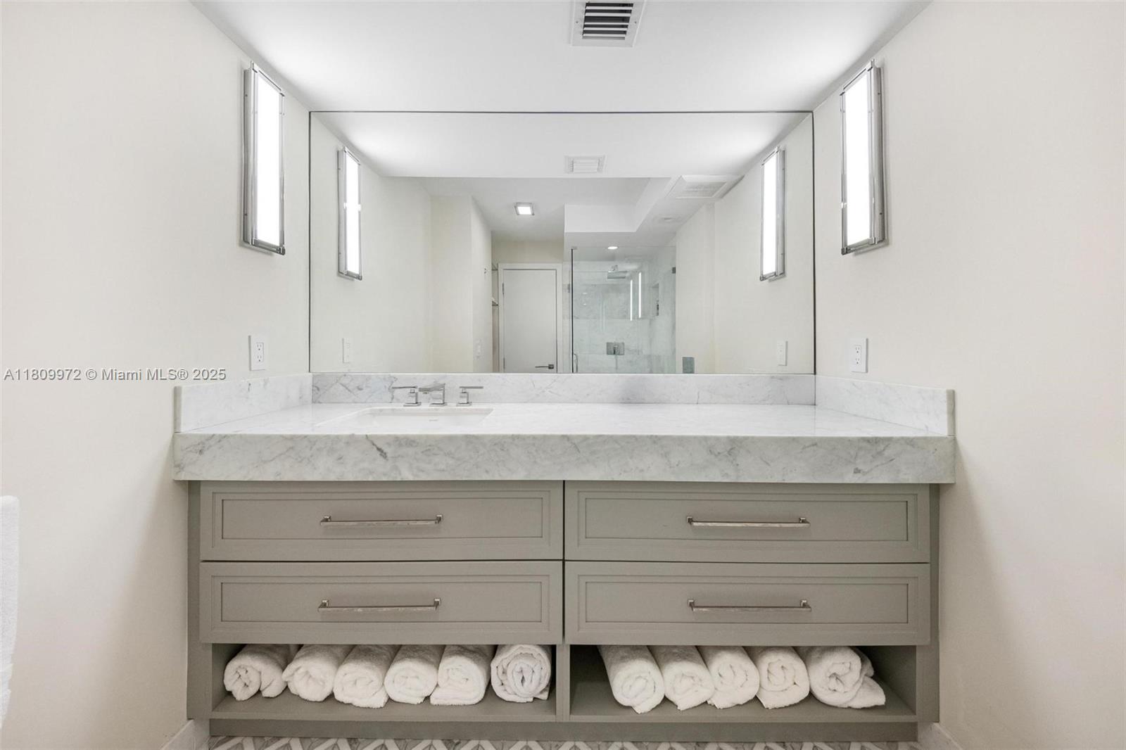 2901 South Bayshore Drive, Unit 17G/H Miami, FL 33133 - Photo 59 of 81 a bathroom with a sink and a mirror