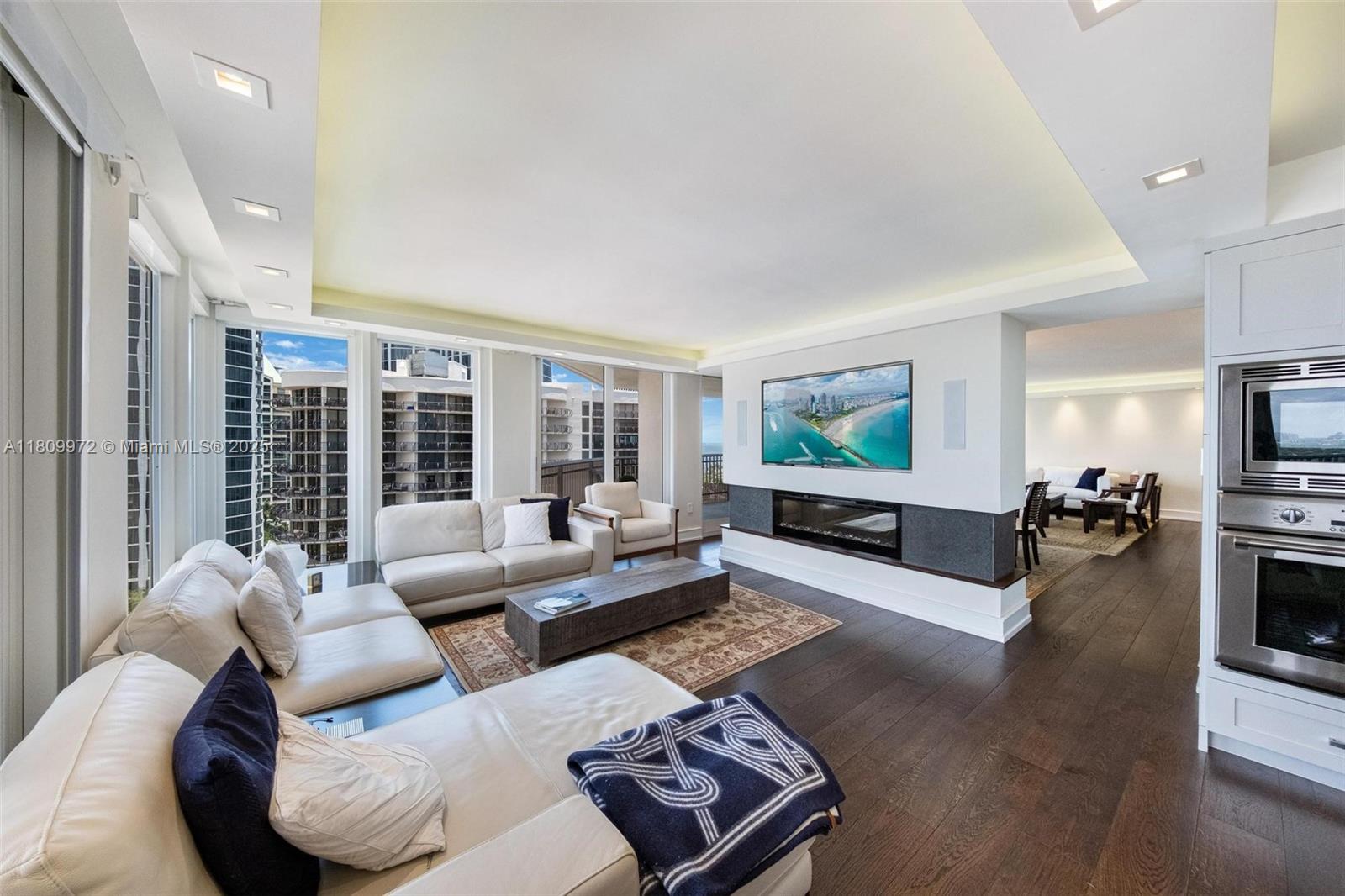 2901 South Bayshore Drive, Unit 17G/H Miami, FL 33133 - Photo 9 of 81 a living room with furniture and a flat screen tv