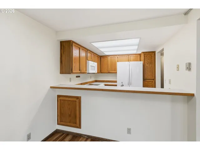 a kitchen with stainless steel appliances a sink stove and cabinets