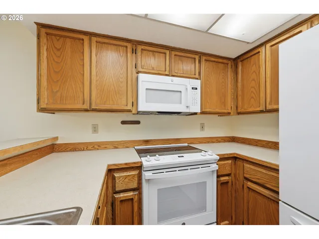 a kitchen with a sink cabinets and appliances