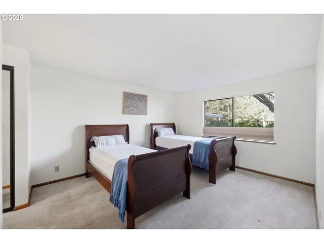 a bedroom with a bed couch and window