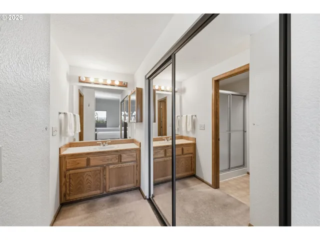 a bathroom with a sink a toilet and a mirror