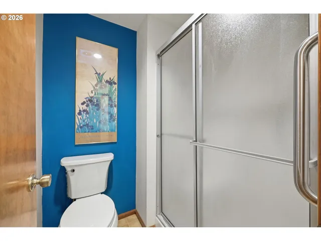 a view of a room with wooden floor and door