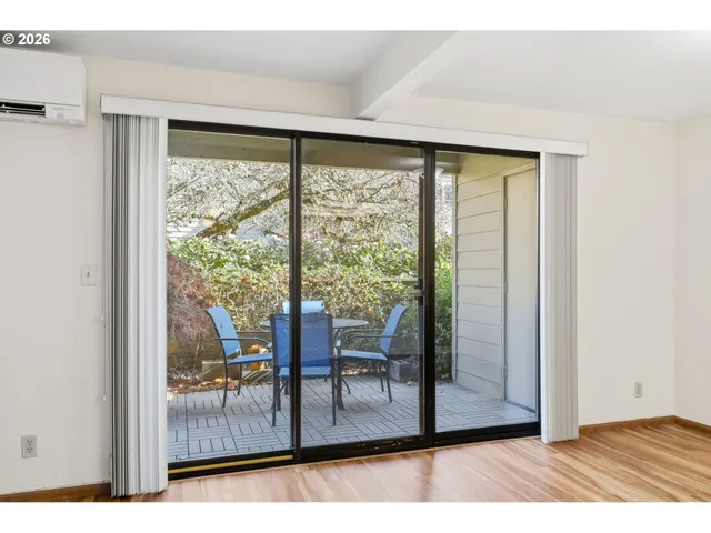 a backyard of a house with table and chairs