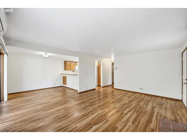 a view of an empty room and wooden floor
