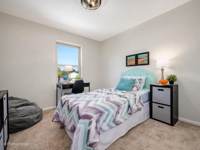 a bedroom with a bed and a desk