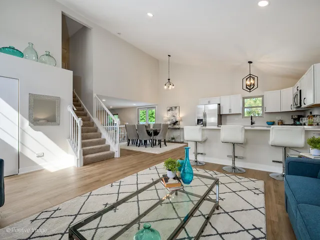 a living room with furniture and a view of kitchen