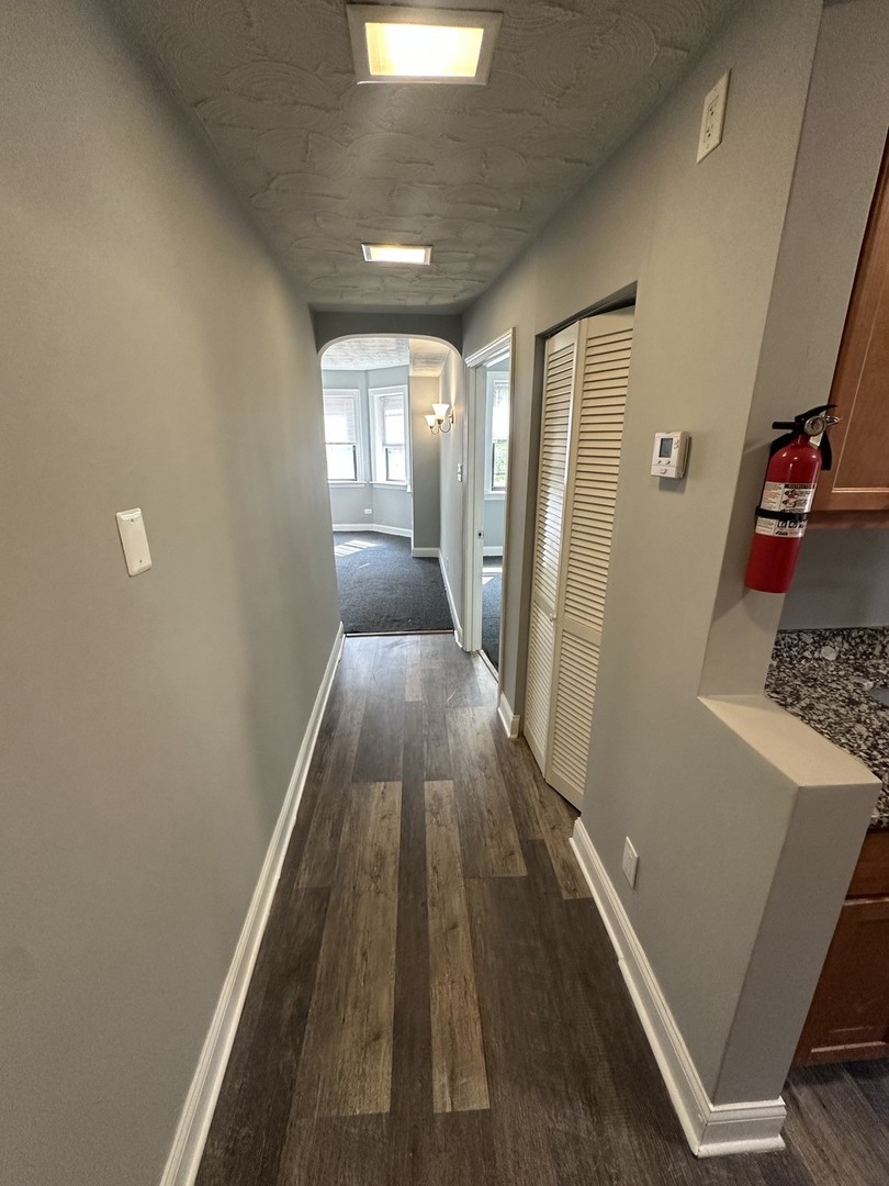 1614 North Harding Avenue, Unit G Chicago, IL 60647 - Photo 11 of 16 a view of a hallway with wooden floor and staircase
