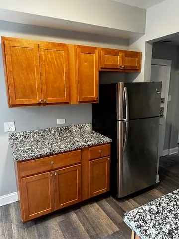 a kitchen with stainless steel appliances granite countertop a refrigerator and a sink