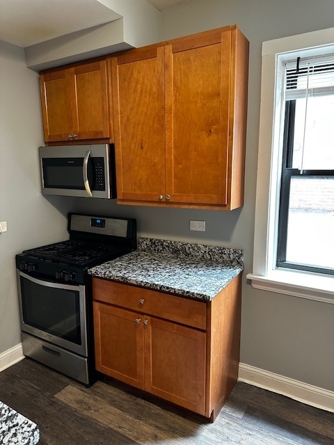 1614 North Harding Avenue, Unit G Chicago, IL 60647 - Photo 6 of 16 a stove top oven sitting inside of a kitchen