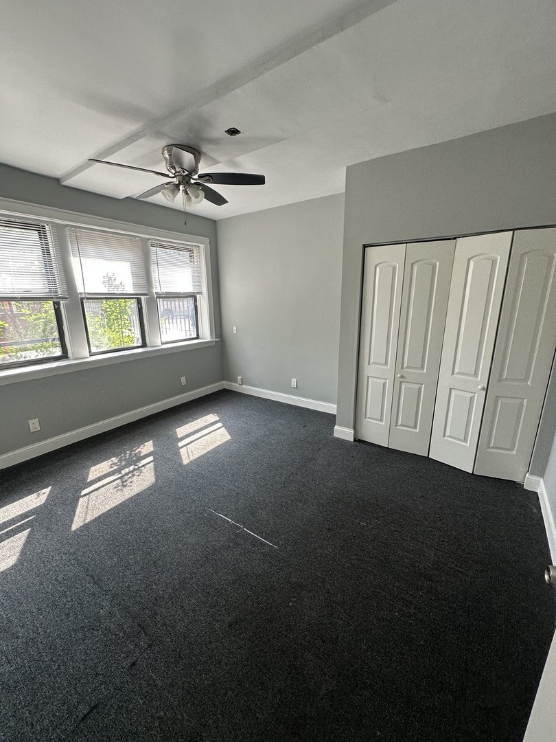 1614 North Harding Avenue, Unit G Chicago, IL 60647 - Photo 9 of 16 an empty room with windows