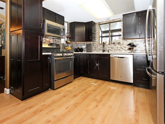 8819 Gardner Road Fox River Grove, IL 60021 - Photo 11 of 24 a kitchen with stainless steel appliances granite countertop a refrigerator stove and oven