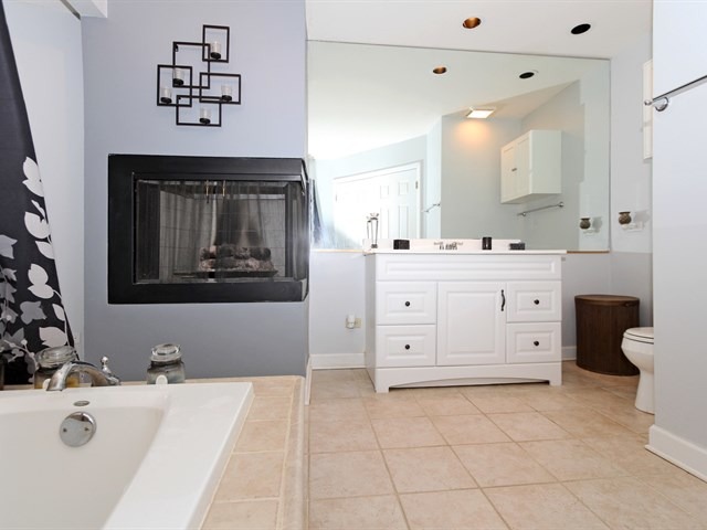 8819 Gardner Road Fox River Grove, IL 60021 - Photo 16 of 24 a spacious bathroom with a tub sink and mirror