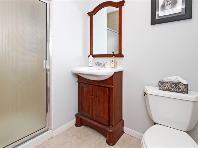 8819 Gardner Road Fox River Grove, IL 60021 - Photo 21 of 24 a bathroom with a toilet a sink and mirror