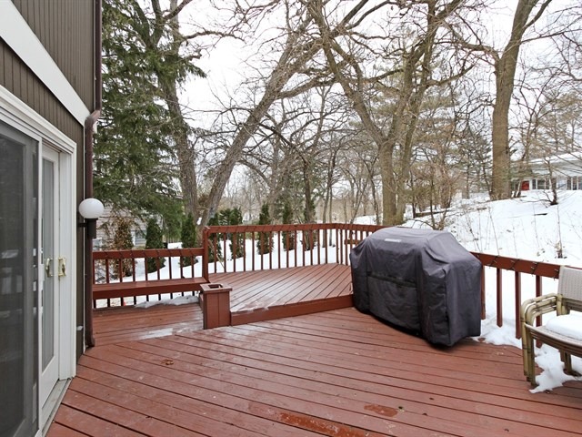 8819 Gardner Road Fox River Grove, IL 60021 - Photo 22 of 24 a view of a deck with table and chairs and wooden floor