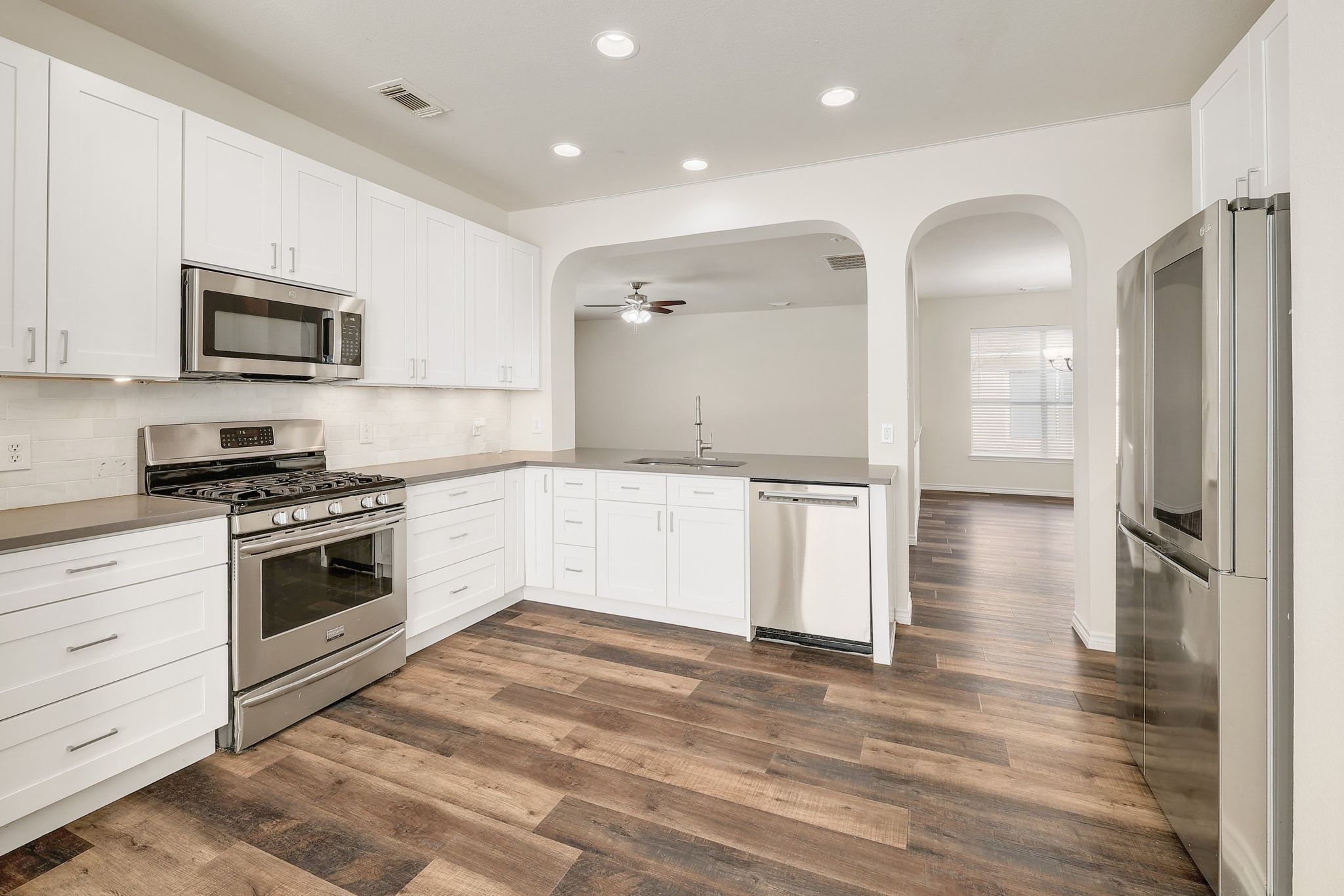 2307 Hayfield Square Pflugerville, TX 78660 - Photo 11 of 40 a kitchen with stainless steel appliances granite countertop a refrigerator and a stove top oven