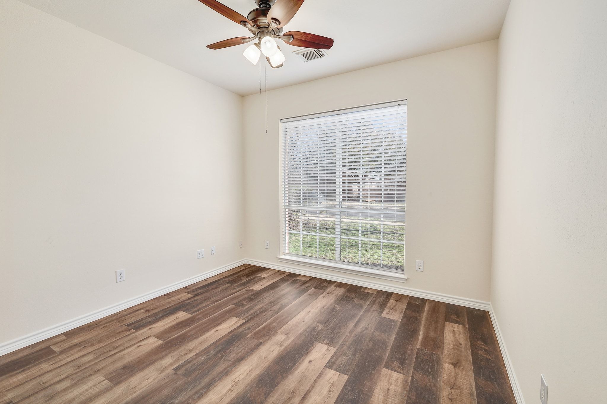 2307 Hayfield Square Pflugerville, TX 78660 - Photo 25 of 40 an empty room with a window and a fan