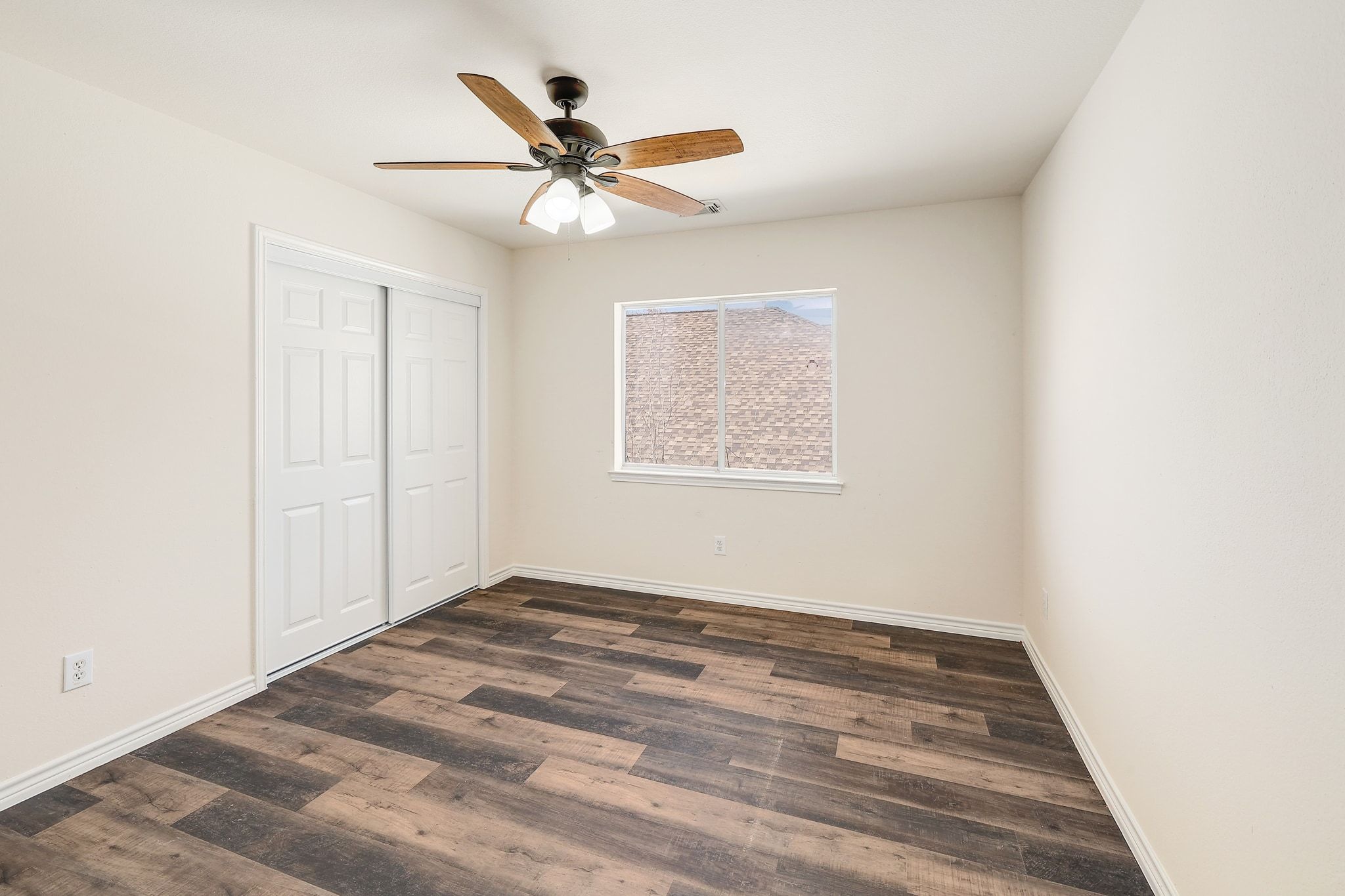 2307 Hayfield Square Pflugerville, TX 78660 - Photo 32 of 40 an empty room with wooden floor fan and windows