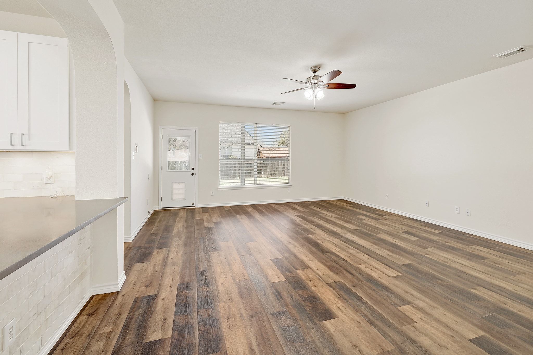 2307 Hayfield Square Pflugerville, TX 78660 - Photo 4 of 40 wooden floor in an empty room with a window