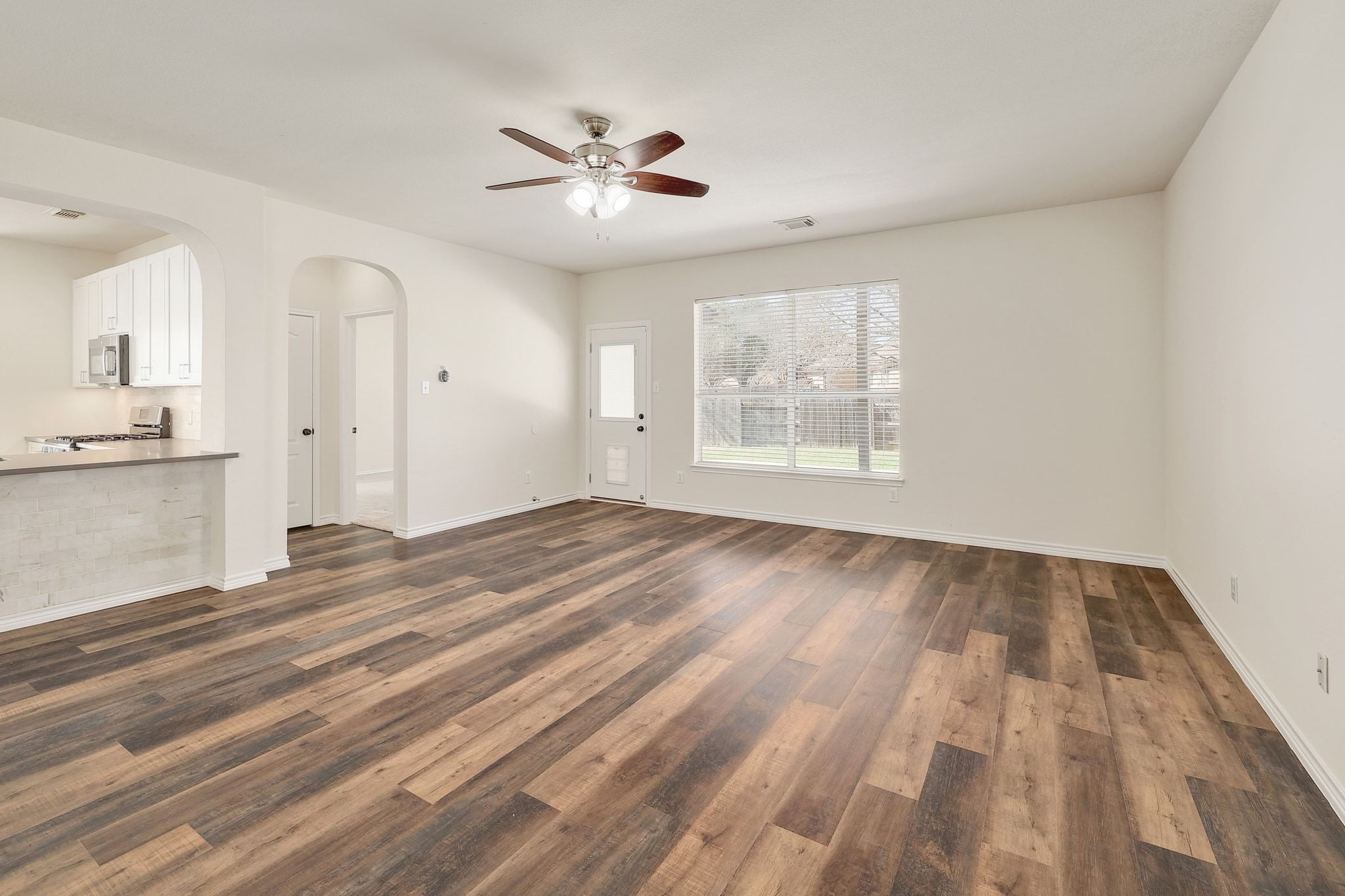 2307 Hayfield Square Pflugerville, TX 78660 - Photo 5 of 40 a view of empty room with wooden floor and fan